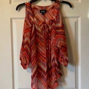 Beautiful-flowing cold shoulder top.